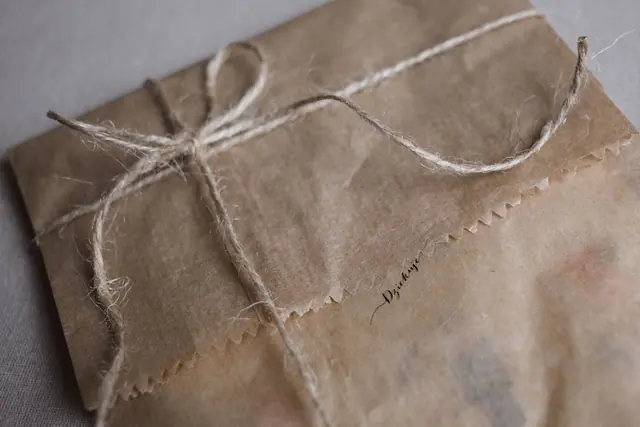 A parcel wrapped in brown paper with natural string
