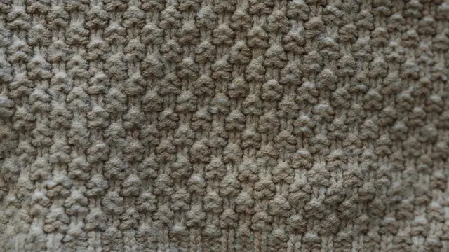 Close texture of beige knit stitches