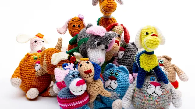 A pile of small crocheted animals on a white background
