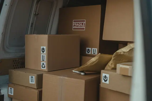 Cardboard boxes stacked inside a delivery van