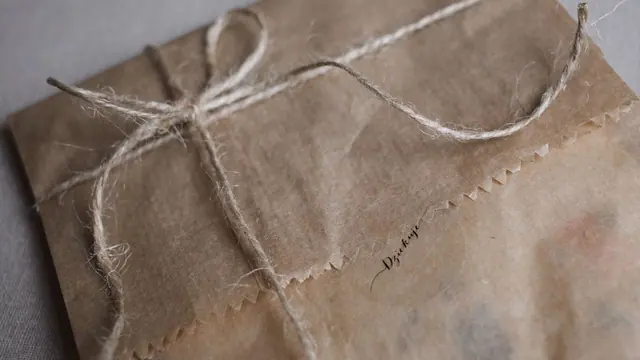 A parcel wrapped in brown paper with natural string