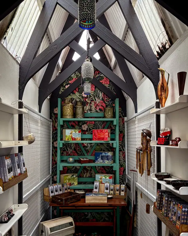 A narrow gift shop with decorated shelves
