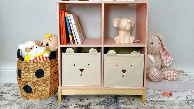 A pastel playroom shelf with toys, books and a basket