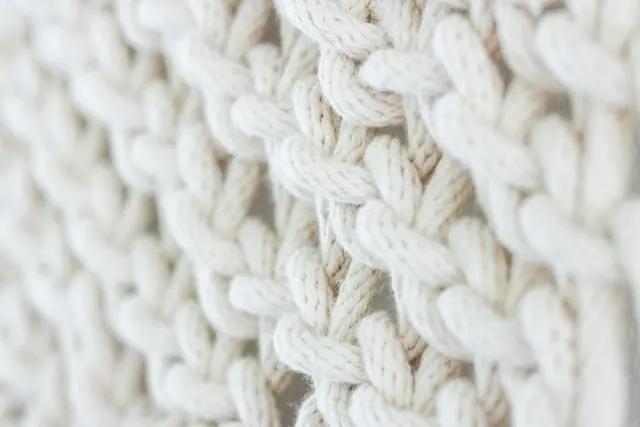 Soft white chunky knit stitches in close up