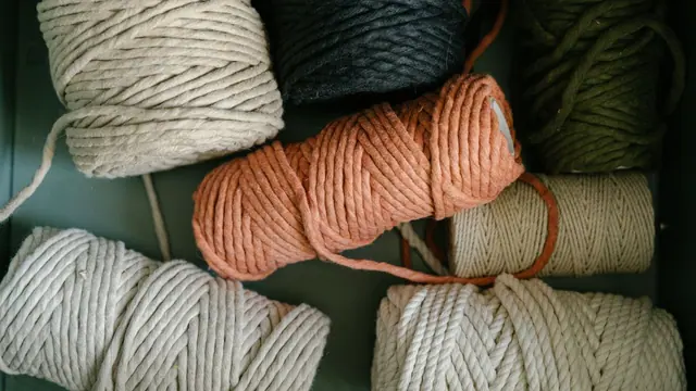Thick cream, orange and olive yarn skeins in a drawer