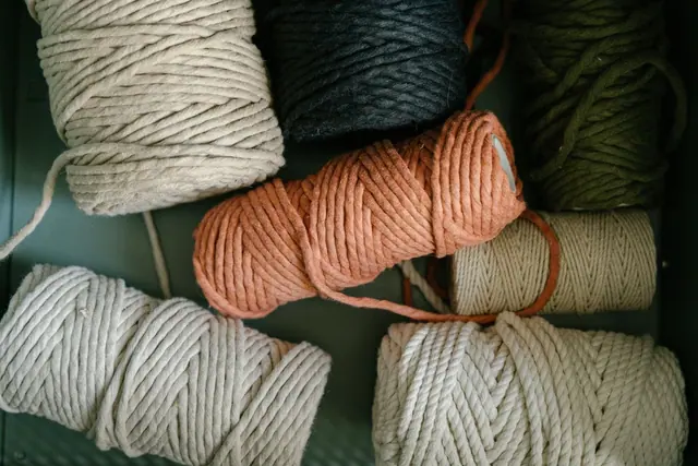 Thick cream, orange and olive yarn skeins in a drawer
