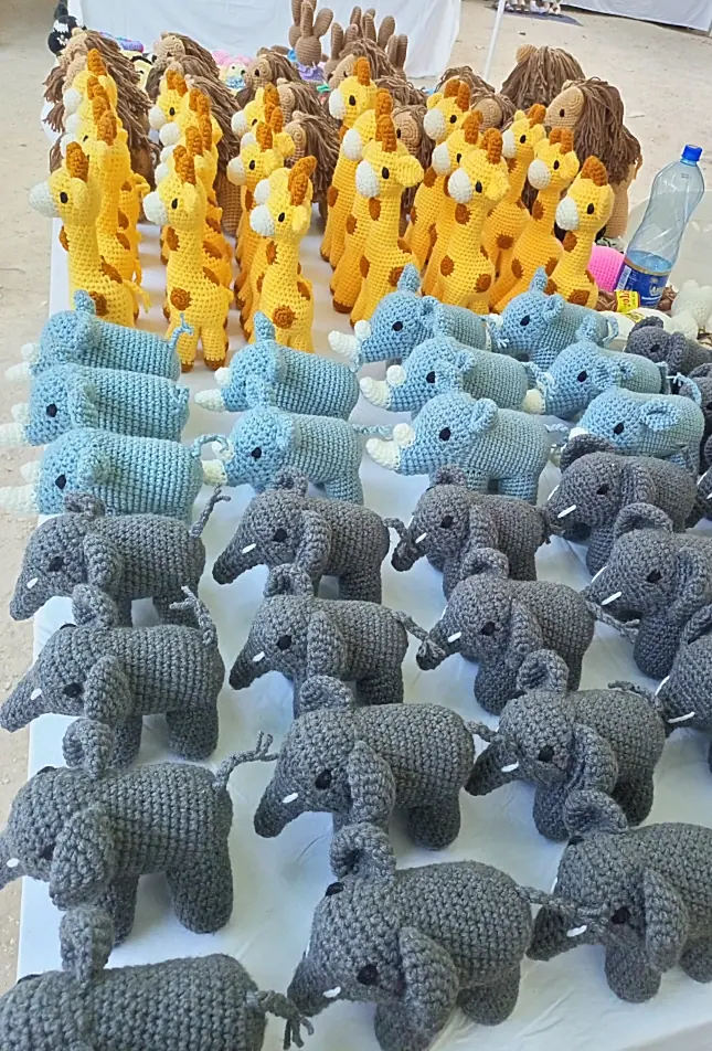 Neat rows of grey elephants and light blue rhinos below a row of yellow giraffes